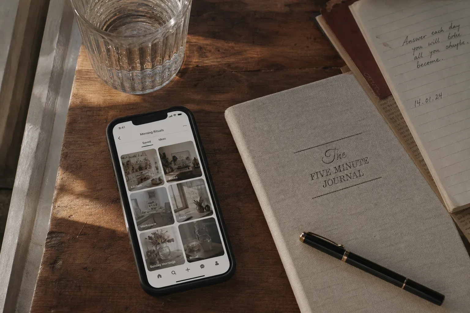 Phone with saved pins beside a quiet notebook